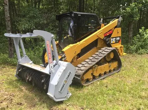Yellow excavator clearing brush in a sunlit forest